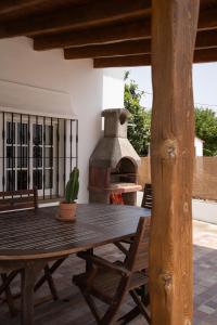 a wooden table with a cactus on a patio at La Huertina C2 in Zahora