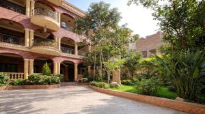 a building with a courtyard in front of it at Villa Golden Sunset Pyramids in Cairo