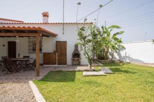 a small yard with a table and a house at La Huertina C1 in Zahora