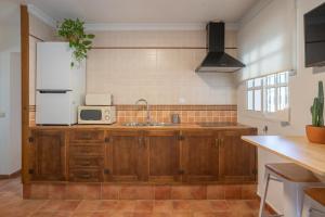 a kitchen with a sink and a microwave at La Huertina C1 in Zahora +8 photos