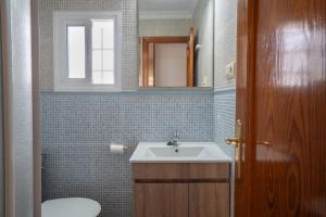 a bathroom with a sink and a toilet and a mirror at La Huertina C1 in Zahora