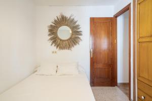 a bedroom with a bed with a mirror on the wall at La Huertina C1 in Zahora