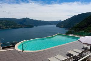 a swimming pool with a view of a lake at Le Sirene in Parzanica +25 photos