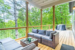 a screened in porch with a couch and a table at The Overlook at Lake James in Nebo