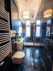 a bathroom with a toilet and a sink at Belle Époque Sopot in Sopot