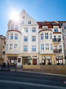 a large white building on the side of a street at Belle Époque Sopot in Sopot