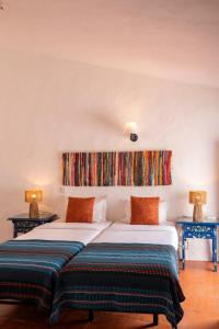 two beds in a room with two lamps at Dom Nuno by Horta da Moura in Monsaraz