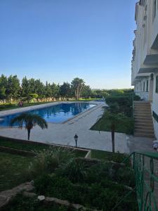 a large swimming pool next to a building at pacotanjawi achakar in Tangier