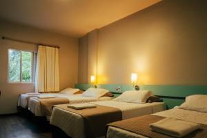 a hotel room with four beds and a window at Real NOB Hotel in Orleans +73 photos
