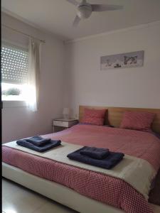 a bedroom with a bed with two towels on it at ESPIGALL in Vilanova i la Geltrú
