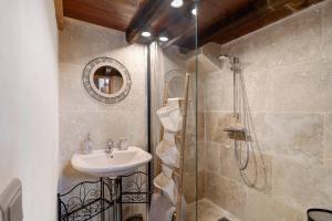 a bathroom with a sink and a shower at Maison Les Rocailles in Saint-Martin-des-Combes +22 photos