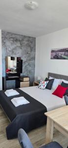 a bedroom with a large bed and a mirror at Casa Del Mar in Primorsko
