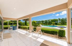 an open living room with a view of a pool at SWISS 61 - Lake Denise in Clermont