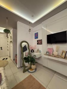 a living room with a couch and a tv on a wall at Flippy Escapes in Zirakpur
