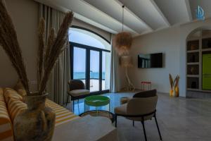 a living room with a couch and chairs at Diar Ayoub in Chebba
