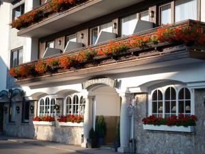a building with flower boxes on the side of it at Genuss - und Vitalhotel Moisl in Abtenau