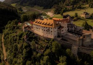an aerial view of a castle on a hill at Castel Badia - The Leading Hotels of the World in San Lorenzo di Sebato