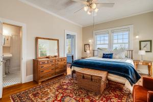 a bedroom with a bed and a dresser and a mirror at Prospect Hill on Main in Waynesville