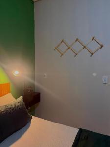 a bedroom with a bed and three lights on the wall at Apartamento próximo ao centro in Primavera do Leste