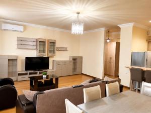 a living room with a couch and a tv at Republic Square Apartment in Yerevan