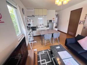 a living room with a table and a kitchen at Transys three in Chitose +108 photos