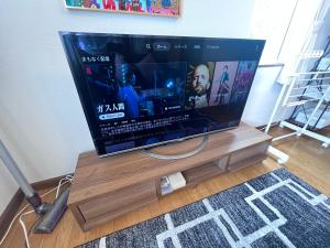 a flat screen tv sitting on top of a wooden stand at Transys three in Chitose