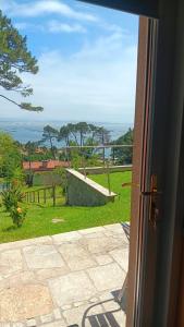 a door to a room with a view of a yard at Areos de Cabío in A Pobra do Caramiñal