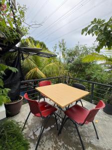 a wooden table and four chairs on a balcony at Art Villa in Alor Setar +14 photos