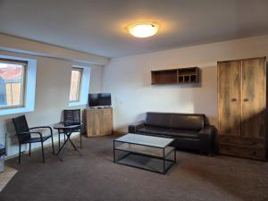 a living room with a couch and a table and chairs at Justinrent Szpitalna 4D-5 in Legnica
