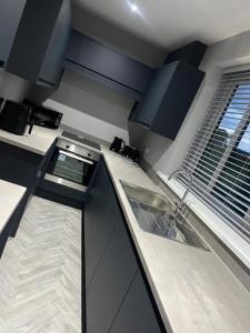 a kitchen with a sink and a counter top at Droversdale Delux hottub and pool table in Bircotes