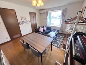 a living room with a table and a couch at Transys three in Chitose