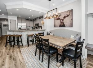 a kitchen and dining room with a wooden table and chairs at Highlands Slopeside in Beaver Creek +40 photos