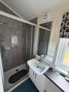 a bathroom with a sink and a shower and a mirror at Sunnyside Lodge in Dunning Station +21 photos