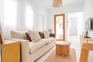 a white living room with a couch and a table at Avocado Corner House - Charco de San Gines By Lanzarote Vacation Homes in Arrecife