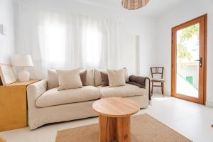 a living room with a couch and a table at Avocado Corner House - Charco de San Gines By Lanzarote Vacation Homes in Arrecife +54 photos