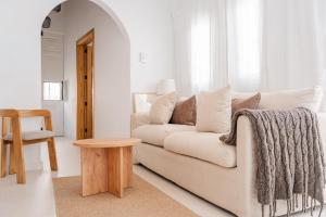 a white living room with a couch and a table at Avocado Corner House - Charco de San Gines By Lanzarote Vacation Homes in Arrecife