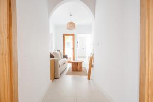a hallway with an archway leading to a living room at Avocado Corner House - Charco de San Gines By Lanzarote Vacation Homes in Arrecife