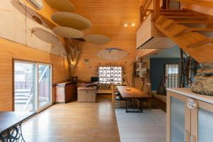 a kitchen with wooden walls and wooden floors and a table at Kussharoko Artemina Lotus in Teshikaga