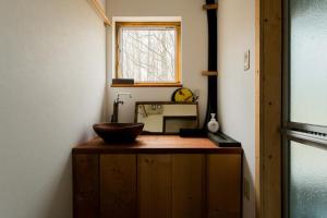 a bathroom with a wooden counter with a bowl on it at Kussharoko Artemina Lotus in Teshikaga +23 photos