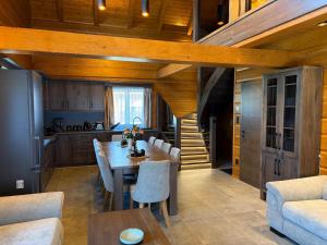 a kitchen and dining room with a table and chairs at Chalupa Nicol in Vítějeves