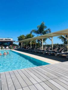 a pool at a resort with people in the water at Premium Sea View in Saint-Raphaël