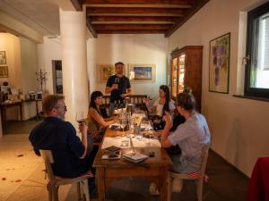 a group of people sitting around a table in a restaurant at Oasi Picolit in Povoletto