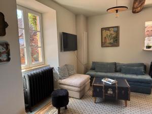 a living room with a couch and a chair at Clos Lavaux in Châtenay