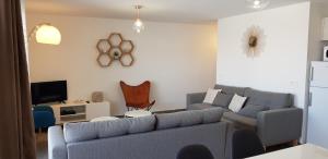 a living room with a couch and a tv at Porto-Vecchio 2-bedroom apartment, pool in Porto-Vecchio