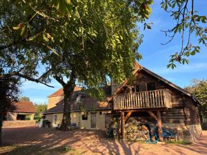 a wooden house with a tree in front of it at Clos Lavaux in Châtenay