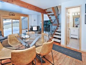 a dining room with a glass table and chairs at Ptarmigan Townhomes 30 in Vail