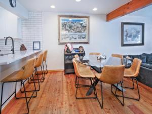 a kitchen and dining room with a glass table and chairs at Ptarmigan Townhomes 30 in Vail