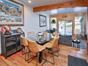 a dining room with a glass table and chairs at Ptarmigan Townhomes 30 in Vail