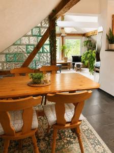 a dining room with a wooden table and chairs at Old Farmhouse Loft near Vaduz in Sevelen