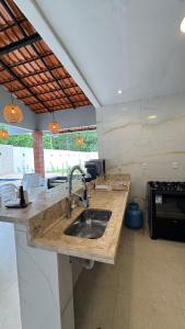 a kitchen with a sink and a counter top at Chácara encantos Iranduba in Iranduba